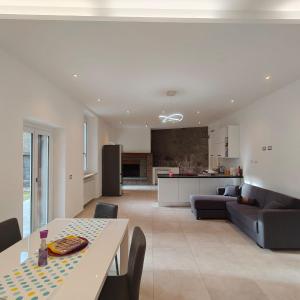 a living room and kitchen with a table and a couch at The Garden Suites in Viterbo