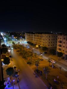 a city street at night with cars and buildings at تجزئة الفتح 925 خريبكة 3 in Khouribga