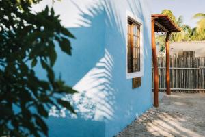 a blue and white building with a window at Paradise Renewed Beach House for Deep Relaxation in El Cuyo
