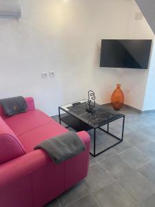 a living room with a red couch and a table at Moreria Suites in Constantina