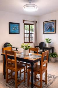a dining room with a wooden table and chairs at Paradise Renewed Beach House for Deep Relaxation in El Cuyo