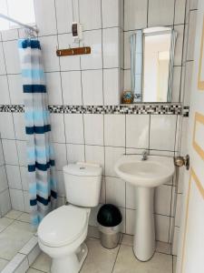 a bathroom with a toilet and a sink at Big Vacation Hostel in Cusco