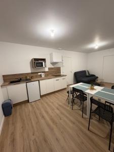 a kitchen and living room with a table and chairs at LONI EXPERIENCES - L'Escale in Challans