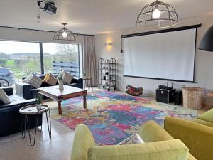 a living room with a projection screen and a large rug at Lime Tree House - Uk49477 in Bulmer
