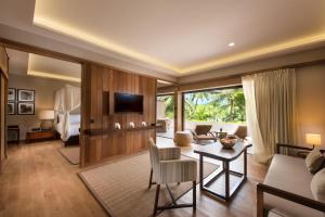 a living room with a couch and a table at Conrad Bora Bora Nui in Bora Bora