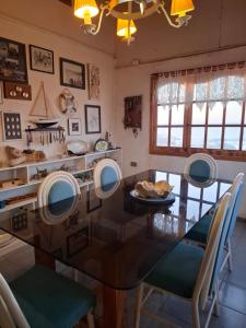 a dining room with a glass table and chairs at Casa de playa con espectacular vista in Islote Ramadas