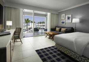 a hotel room with a bed and a living room at Hotel del Coronado, Curio Collection by Hilton in San Diego +177 photos