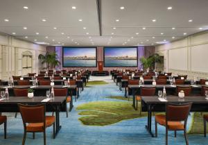 a large room with tables and chairs and large screens at Hotel del Coronado, Curio Collection by Hilton in San Diego