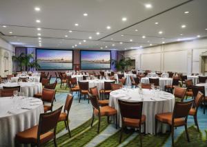 a banquet room with tables and chairs and large screens at Hotel del Coronado, Curio Collection by Hilton in San Diego