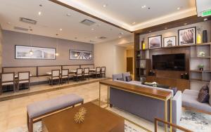 a lobby with a waiting room with chairs and a tv at Hampton Inn By Hilton Tijuana in Tijuana +74 photos