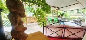 a patio with a table and a potted plant at Haekua Chez Mel in Nuku Hiva