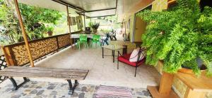 a balcony with a bench and a table and chairs at Haekua Chez Mel in Nuku Hiva