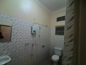 a bathroom with a toilet and a sink at Ark House in Soroti