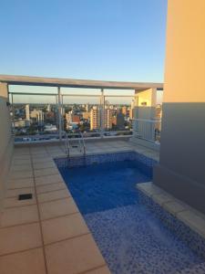 a swimming pool on the roof of a building at Departamento equipado en el macrocentro santa fe in Santa Fe