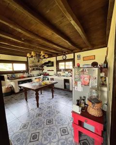 a kitchen with a refrigerator and a table in it at el corazón del cerro in Melipilla