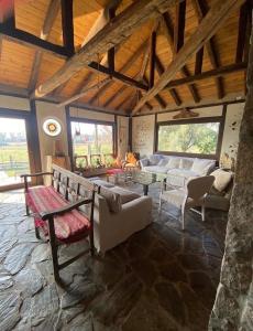 a large living room with couches and a stone floor at el corazón del cerro in Melipilla