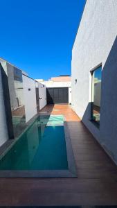 a swimming pool in the middle of a building at Casa Condeixa in Cabo Frio
