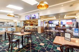 a restaurant with tables and chairs and a bar at Kingsgrove Hotel in Sydney +23 photos