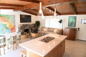a kitchen and living room with a couch and a fireplace at Twelve Senses Retreat in Encinitas