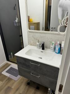 a bathroom with a sink and a mirror at Vila Bella in Lugugnana +30 photos