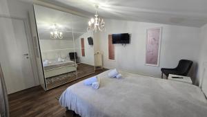 a bedroom with a large bed and a mirror at Vila Bella in Lugugnana