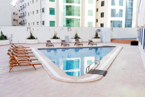 a swimming pool on top of a building at Al HAYAT PALACE HOTEL in Sharjah