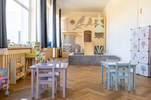a room with two tables and chairs and a counter at Hotel Perła Południa in Rytro