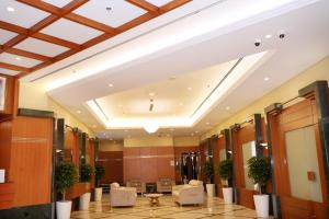 a lobby of a building with a large ceiling at Al HAYAT PALACE HOTEL in Sharjah