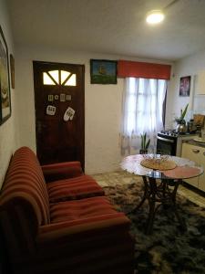 a living room with a couch and a table at Alojamiento Victoria in Montevideo