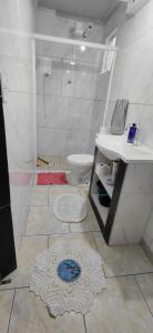 a bathroom with a shower and a sink and a toilet at Pousada Familiar 03 in Rio do Sul