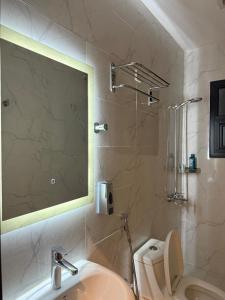 a bathroom with a sink and a shower and a toilet at Sunshine Flat in Al Khobar +26 photos