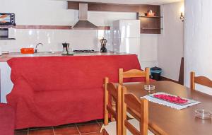 a kitchen with a table with a red table cloth on it at La Cuadra in Málaga