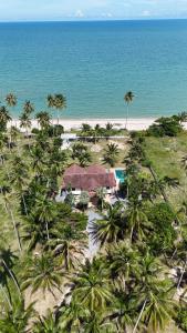 an aerial view of a resort on a beach with palm trees at Klai house beach pool villa , Klai ,Thasala, Nakhon si Thammarat in Ban Phang Pling