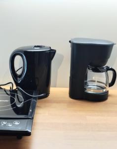 a coffee pot sitting on top of a toaster at Langenfeld City Apartment in Langenfeld