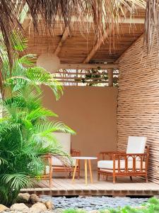 a patio with two chairs and a table at Casa BLU in Máncora +13 photos