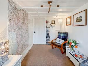 a living room with a chair and a door at Hyfrydle Cottage in Talysarn +26 photos