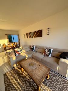 a living room with a couch and a coffee table at Casa Julio-Rooftop Terrace & Pool 5 Min to Beach in Carvoeiro