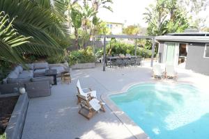 a patio with a pool and chairs and a table at Twelve Senses Retreat in Encinitas
