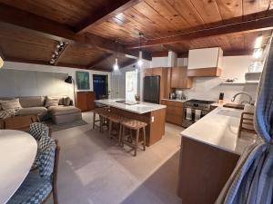 a kitchen and living room with wooden ceilings at Twelve Senses Retreat in Encinitas
