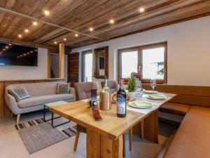 a living room with a wooden table and a couch at Golden Hirsch in Rauris