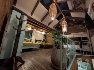 a living room with a staircase and a bedroom at Cabaña tipo loft in Usaquén