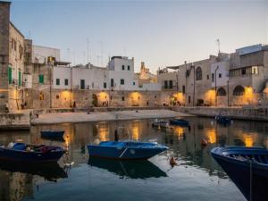 a group of boats in the water in a city at Dimora Aversa in Monopoli