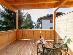a screened porch with a table and chairs on it at Haus Tauernblick Top 4 in Jochberg