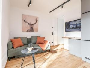 a living room with a couch and a table at Haus Tauernblick Top 4 in Jochberg +26 photos