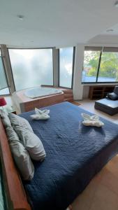 a bedroom with a large bed with two pillows on it at Residencia privada de 10 habitaciones para 20 personas in Chiconcuac +36 photos