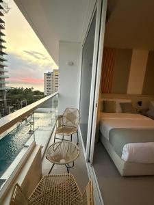 a hotel room with a bed and a balcony at Porto Horizonte Suite 735 in Santa Marta +19 photos