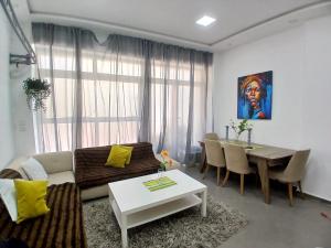 a living room with a couch and a table at Elégance & Confort in Rabat