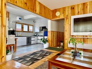 a living room with a table and a kitchen at Sompal Service Apartment in Paro