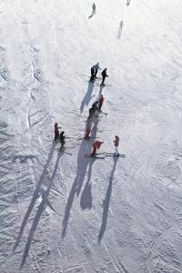 a group of people skiing down a snow covered slope at Villa Blackreindeer in Kolari