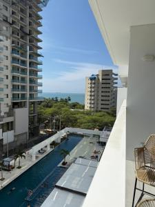 a view from the balcony of a building with a swimming pool at Porto Horizonte Suite 735 in Santa Marta